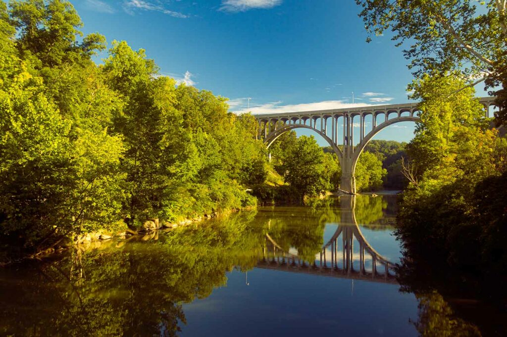 Arch bridge spanning a river in Cuyahoga Valley National Park in Ohio