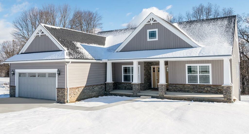 Exterior of new home in the winter with snow on the roof