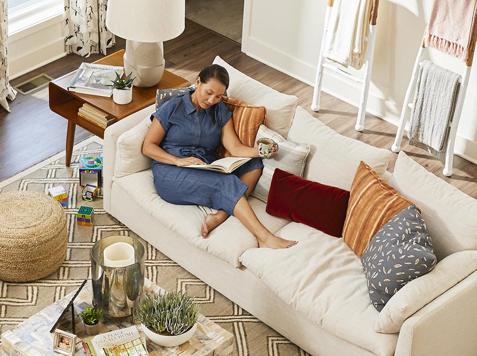 Woman relaxing on the couch with a cup of coffee