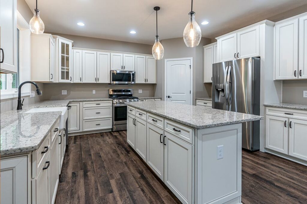 KItchen-with-white-cabinets-and-granite-countertops-on-island