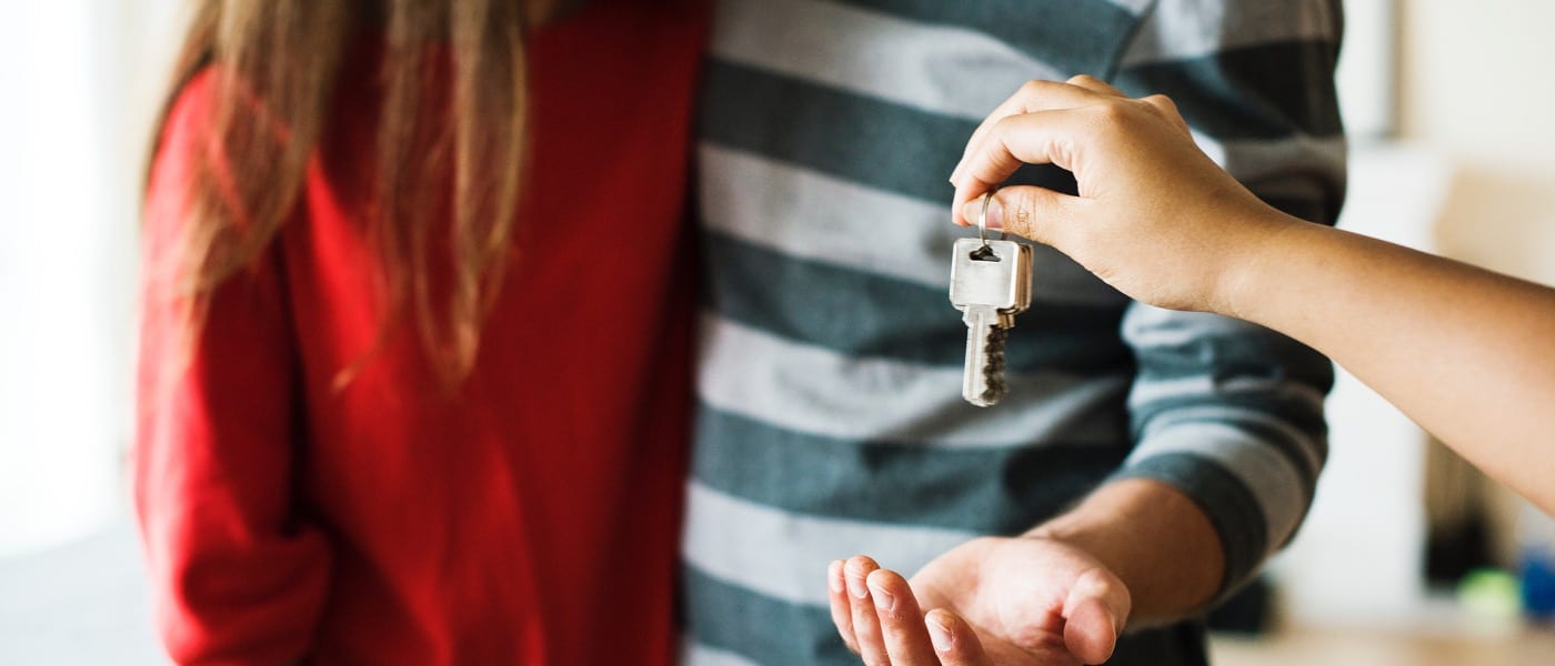 Couple being handed the keys to their new home