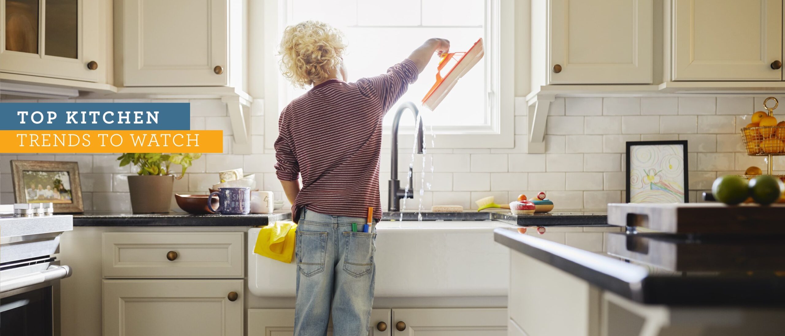 Kid standing at sink in new home kitchen